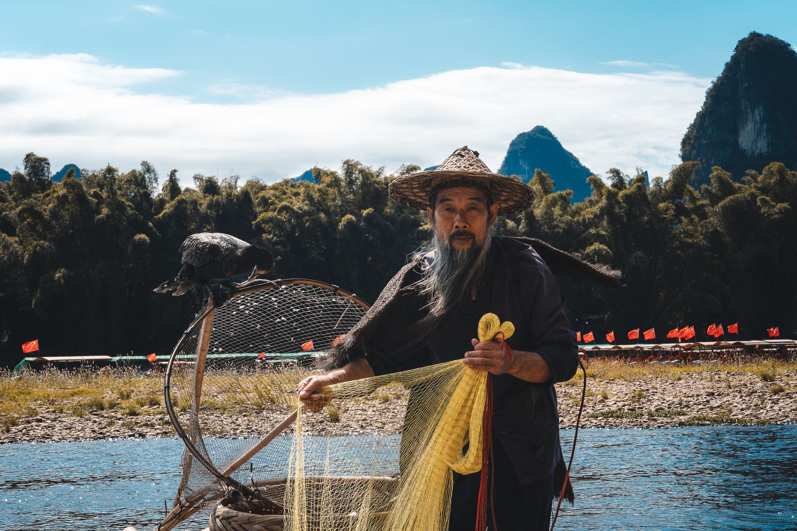 A cormorant fisherman on the Li River near Guilin, the same river setting used for the Impression Liu Sanjie show