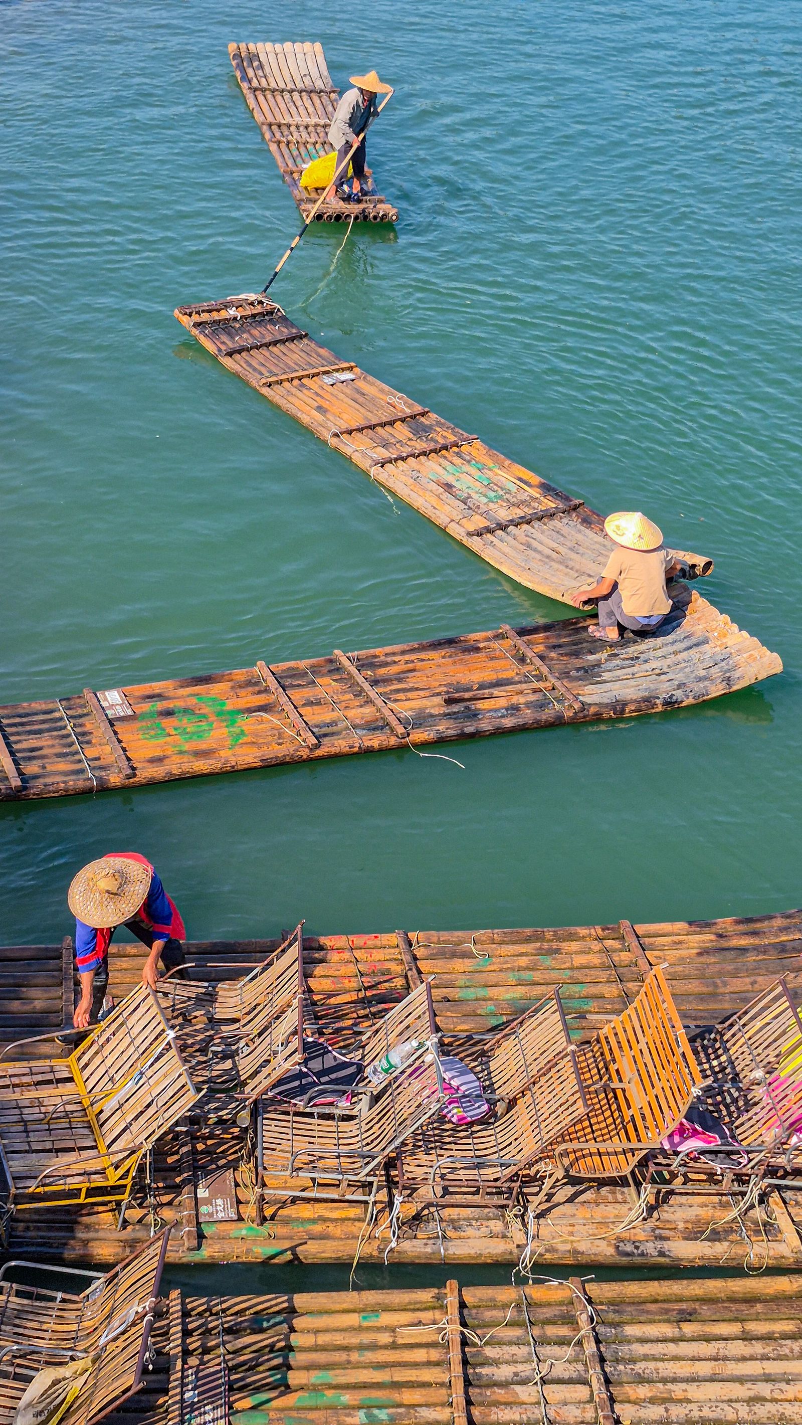 A bamboo raft on a river between karst hills