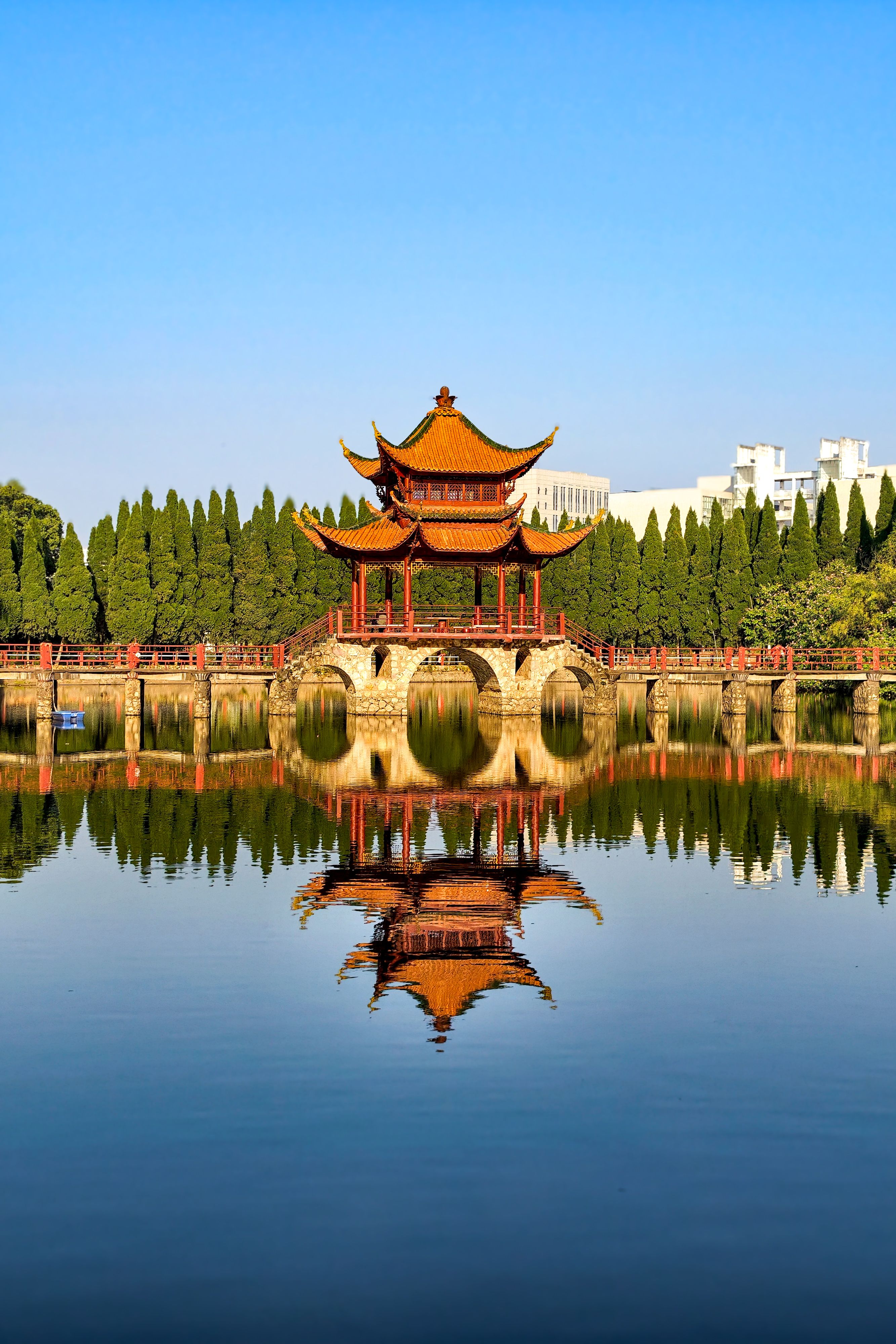 A traditional Chinese pavilion reflected in a lake
