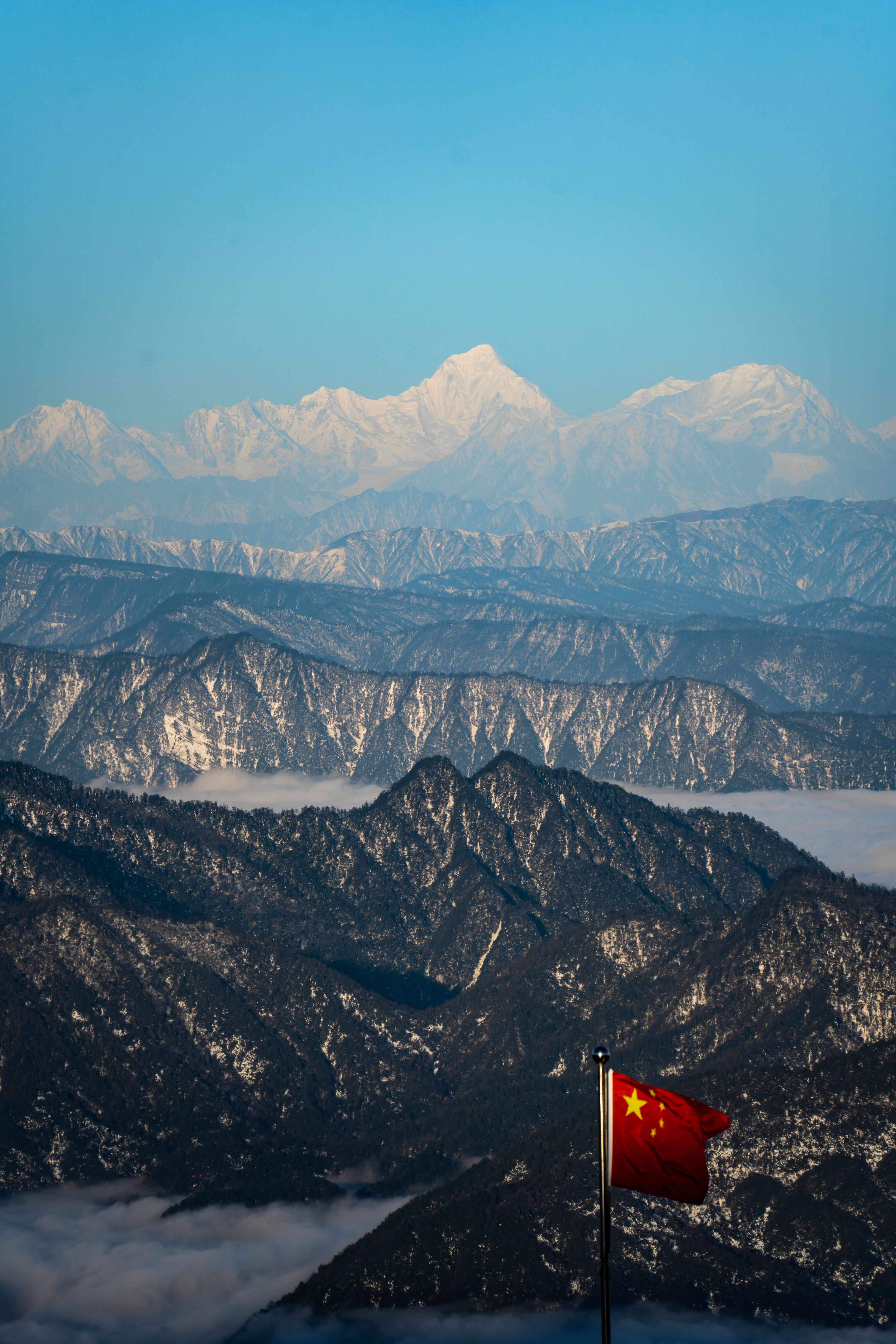 Green mountains with a Chinese flag in China