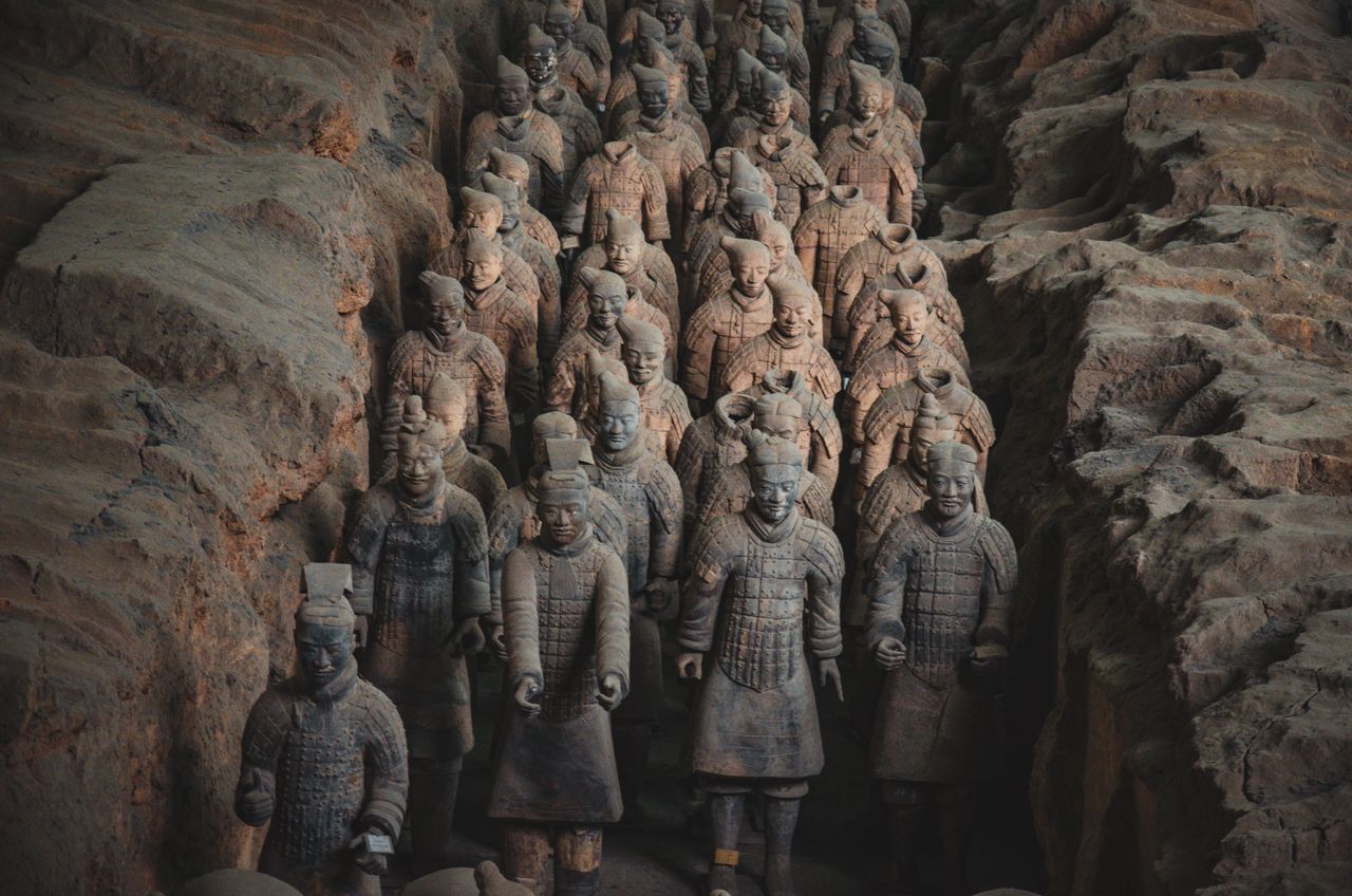 Ranks of Terracotta Army warriors standing in the excavation pit