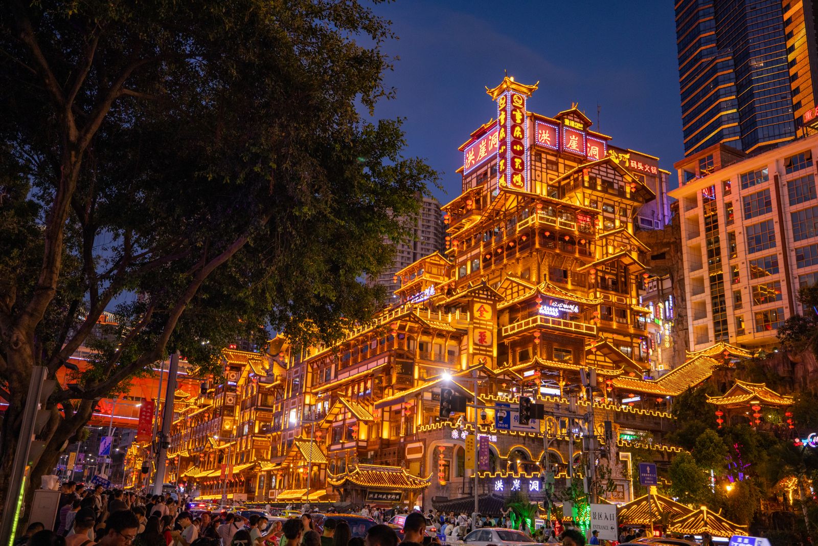 The Hongyadong stilted-house complex illuminated at night above the Jialing River in Chongqing