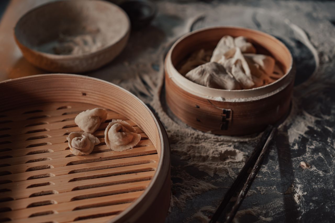 Dumplings stacked on a bamboo steamer