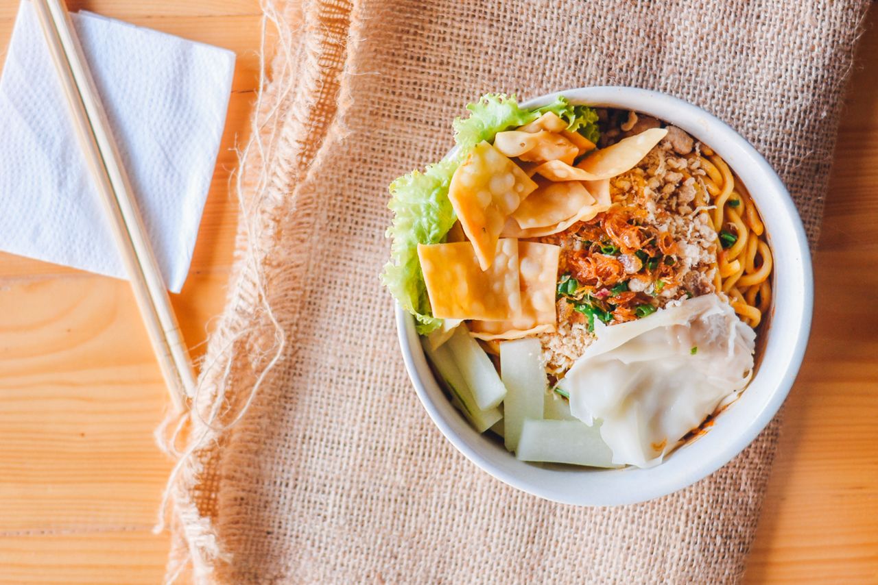 A bowl of Chinese cold rice noodles with vegetables