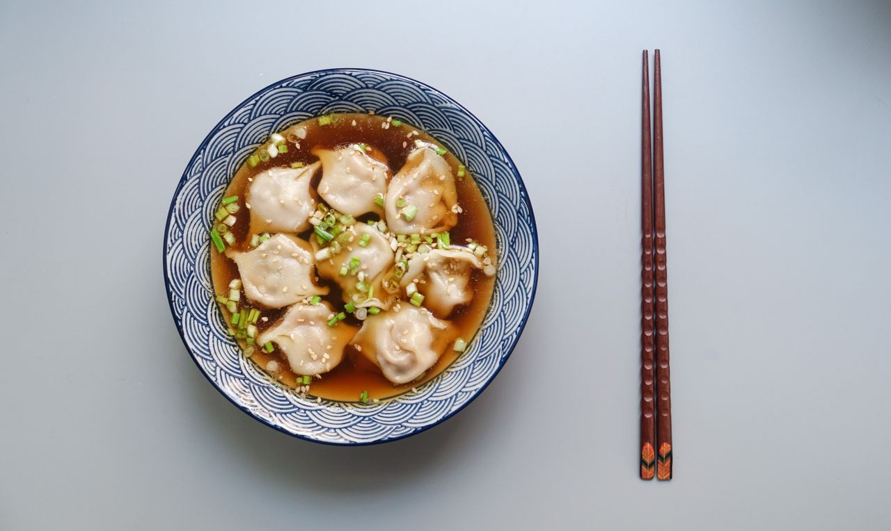 A bowl of Chinese mutton soup with chopsticks
