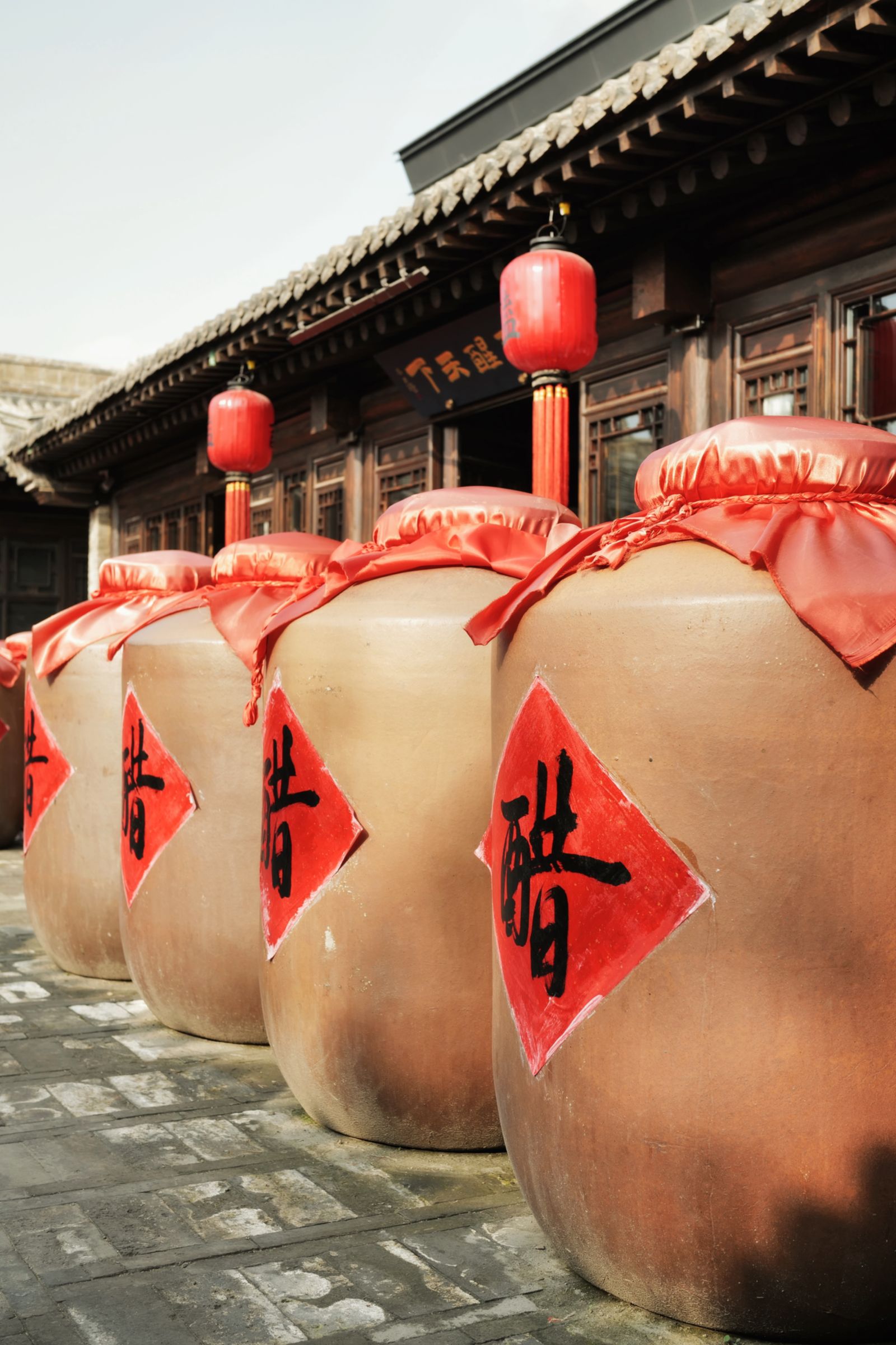Traditional Chinese fermentation jars with red seals