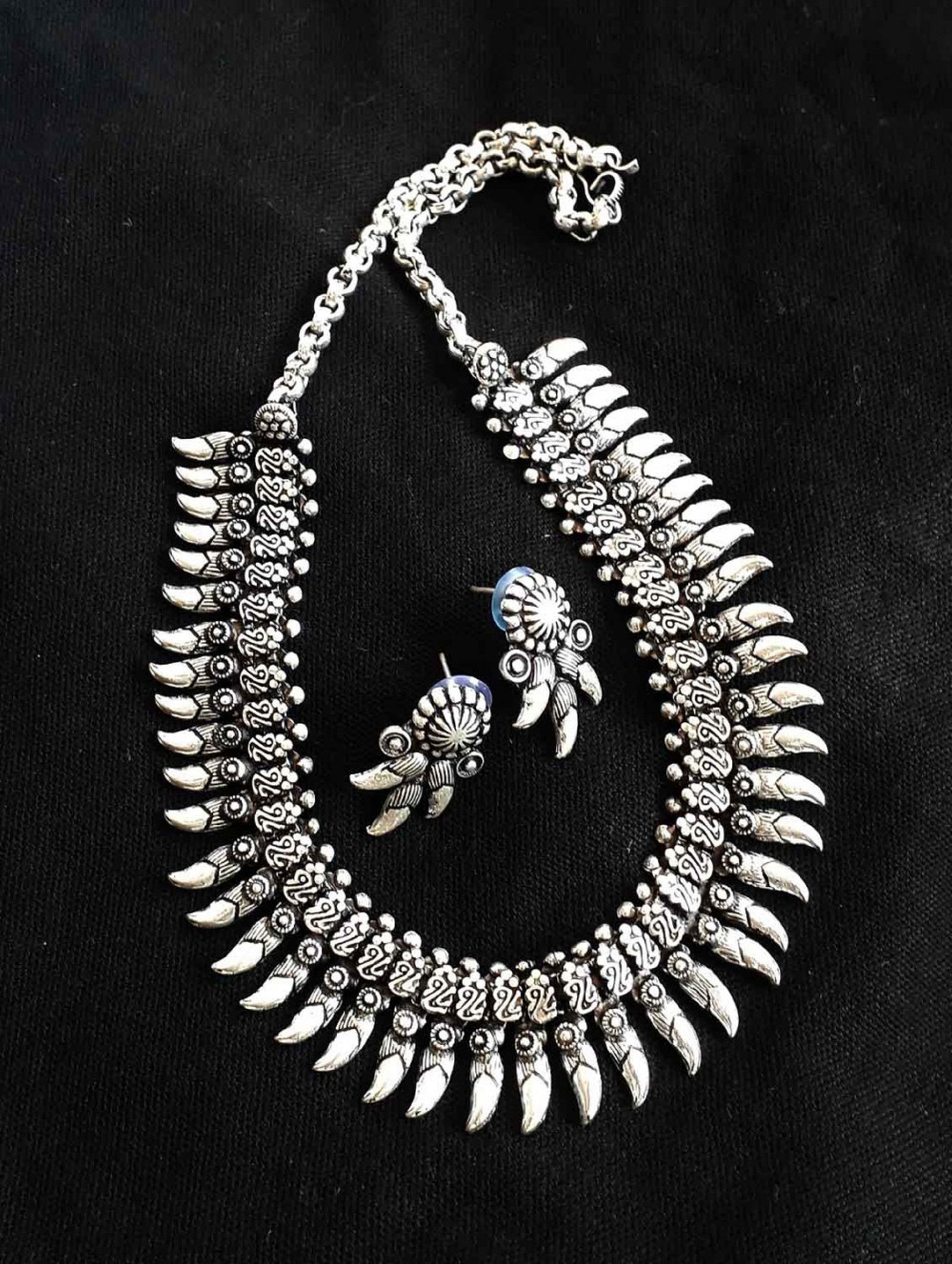 A silver necklace and earrings