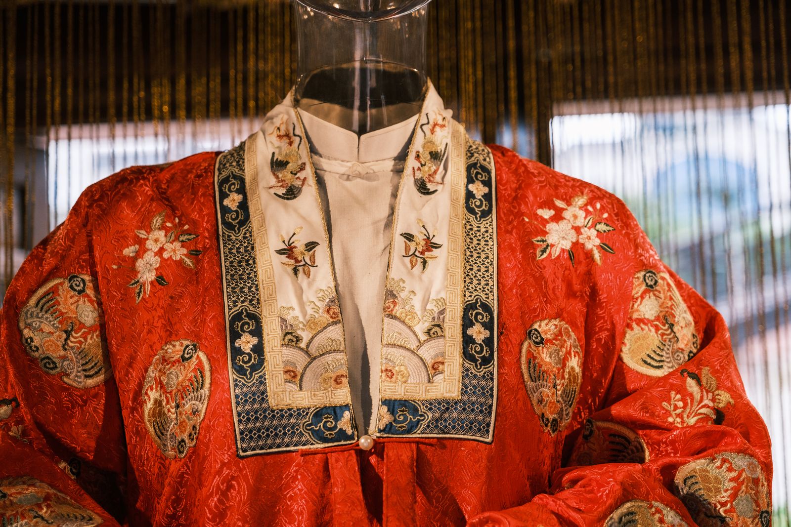 A traditional embroidered Chinese robe on display