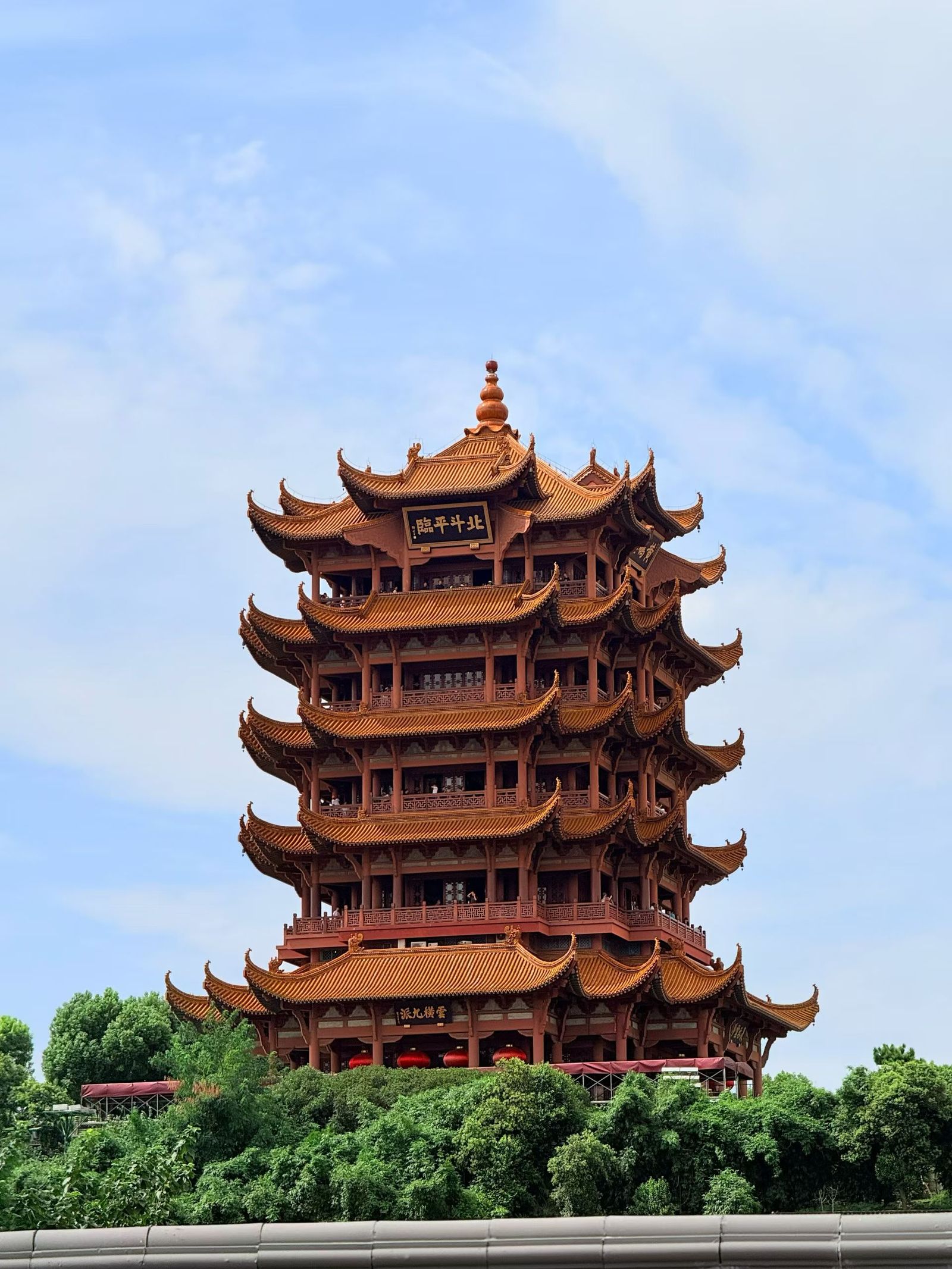 The five-tiered Yellow Crane Tower, a traditional Chinese pagoda with yellow glazed tiles, rising on Snake Hill in Wuhan