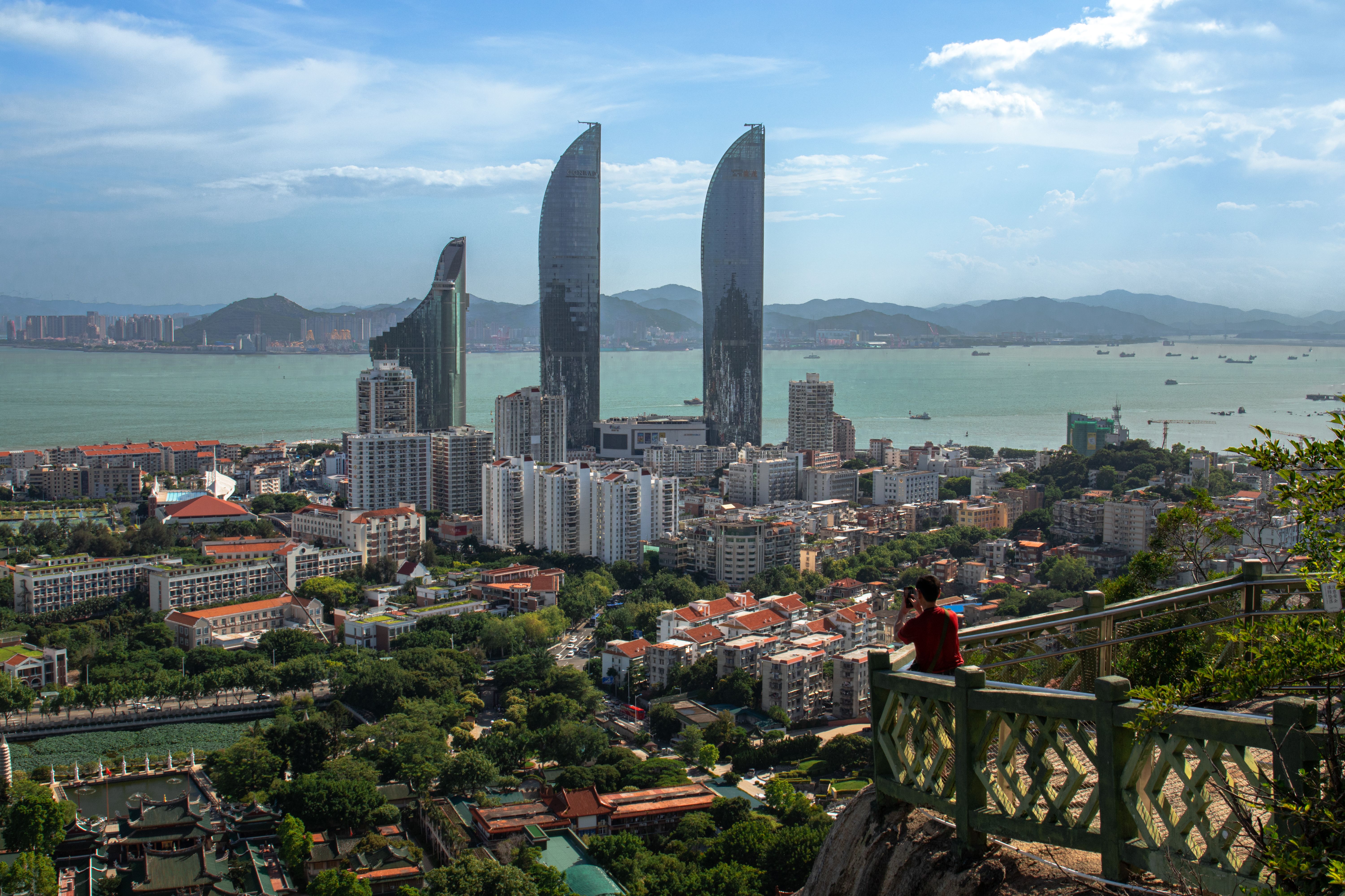 Aerial view of Xiamen city skyline and coastline at dusk